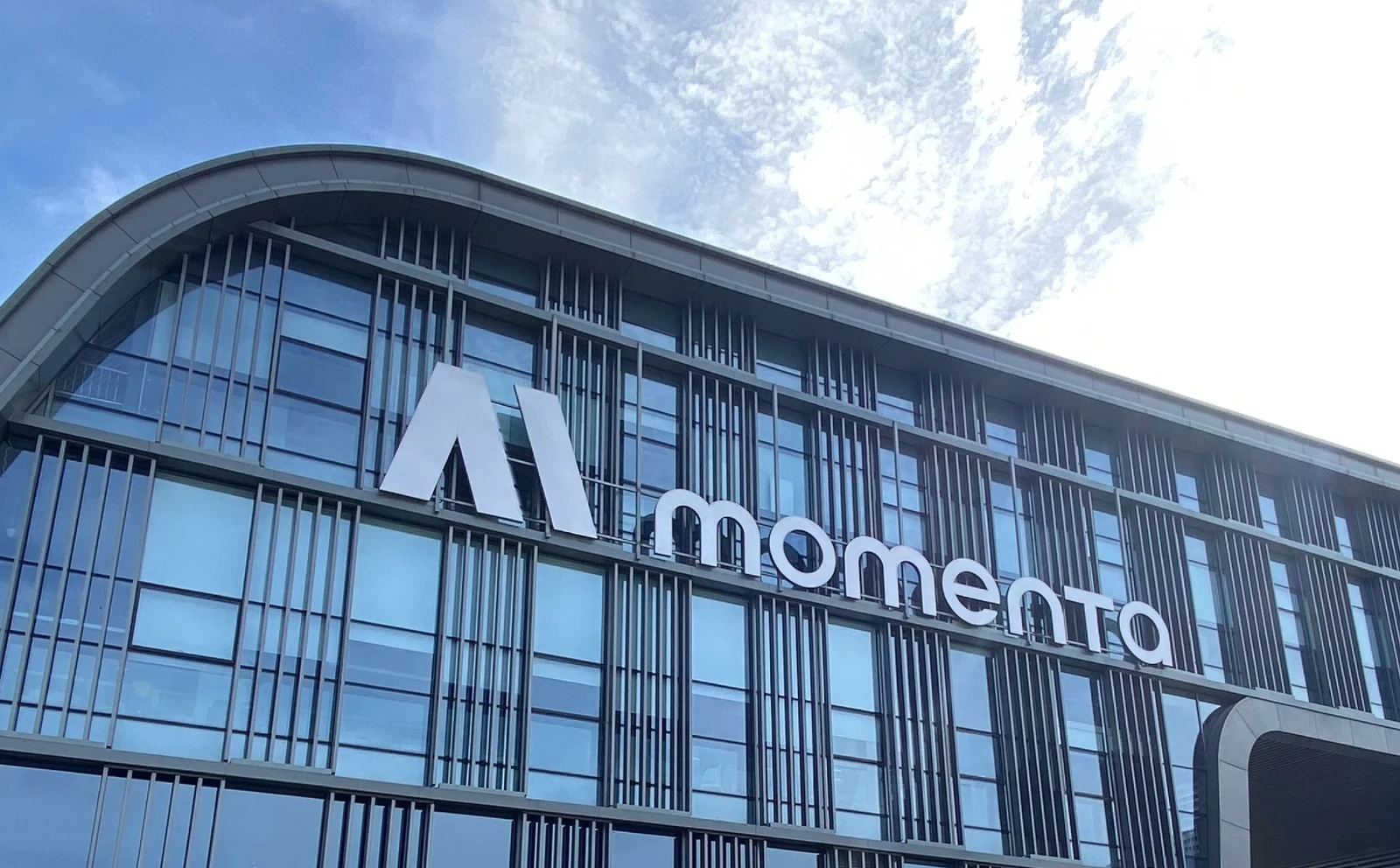Momenta-branded building exterior, from the client's official news imagery
